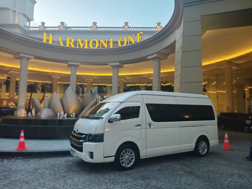 Batam Van Transport - Toyota Hiace parked in front of Harmoni One Hotel Batam